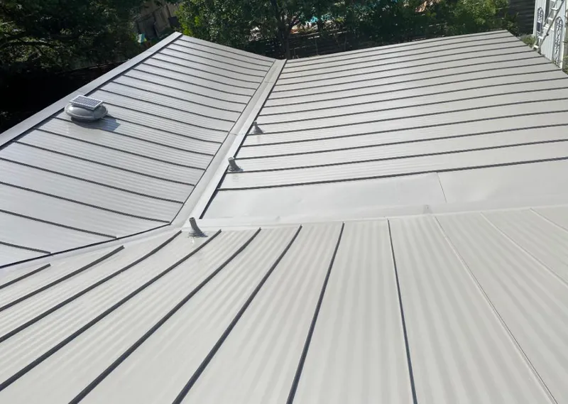 Solar attic fan installed on a metal roof for Roof Ventilation in Lake Ridge