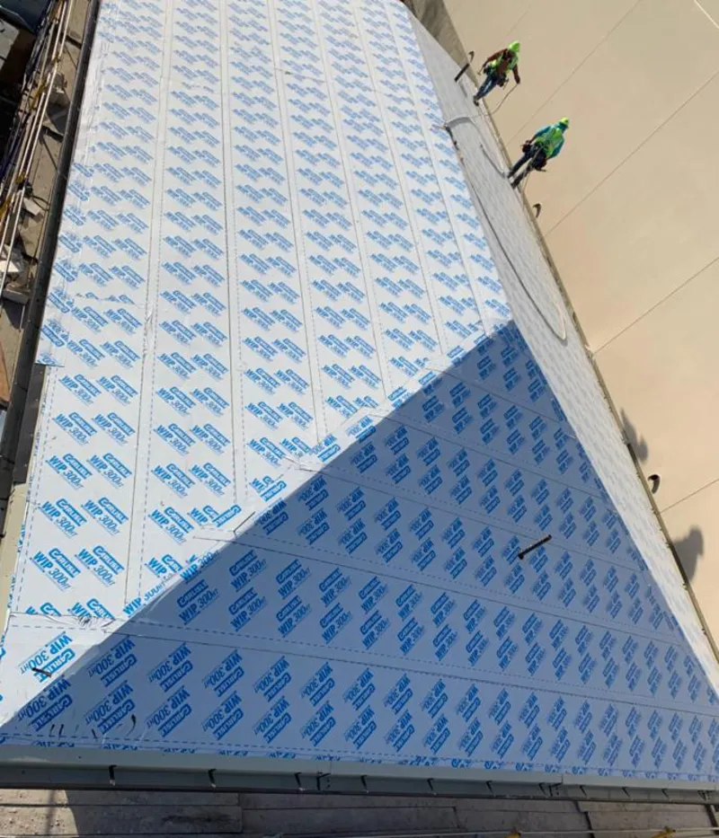 Professional roofers installing underlayment on a metal roof in Lake Ridge